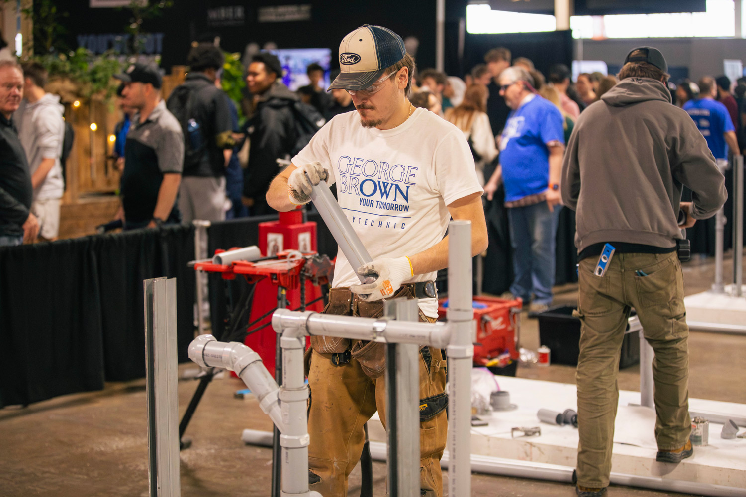 A George Brown student competes in the plumbing competition at Skills Ontario