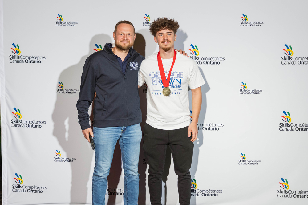 Andrea Marinelli poses with his gold medal and coach