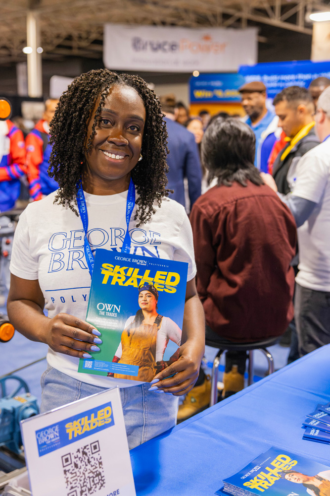 Keshia Fortune holds a Skilled Trades brochure at the Skilled Trades Ontario competition