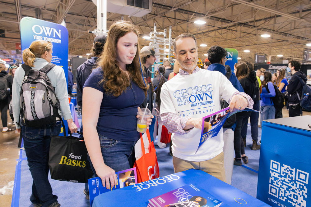 Students talk with faculty at the George Brown booth at Skills Ontario