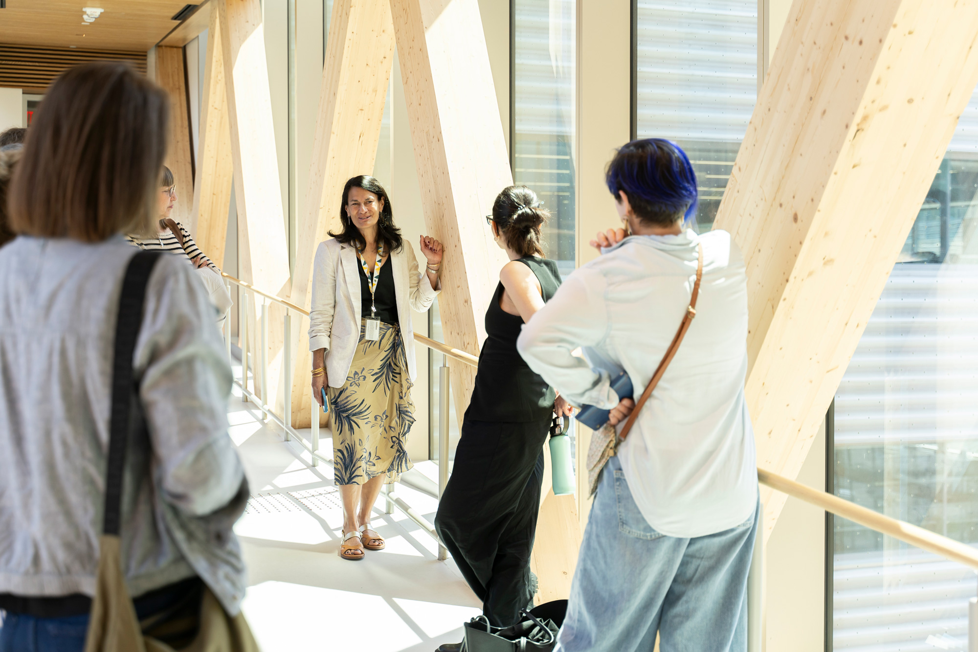 Nerys Rau leads a tour through the wooden and glass bridge connecting Limberlost Place to 51 Dockside for Climate Week.