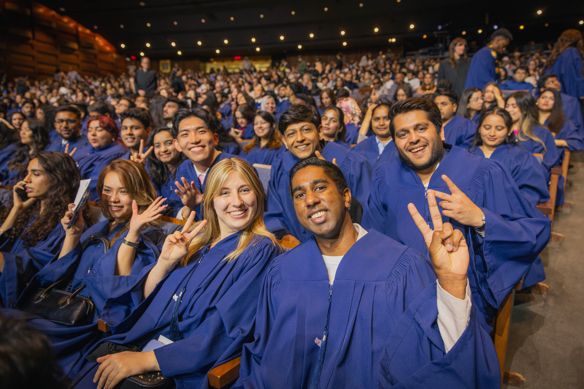 2026 graduates smile and pose at the Convocation ceremonies at Meridian Hall.