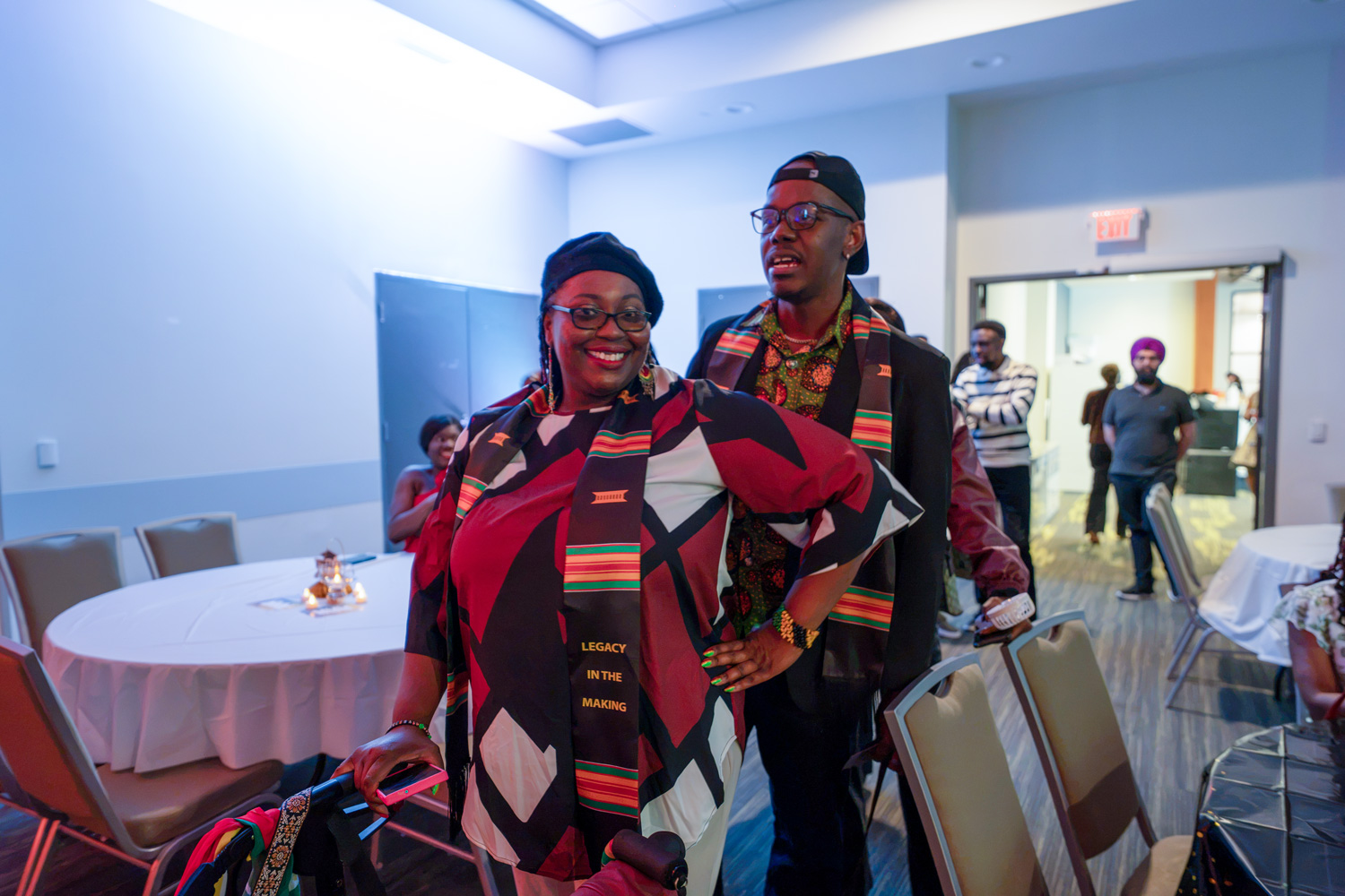 Two new grads wear their Kente stoles at the Legacy in the Making event.