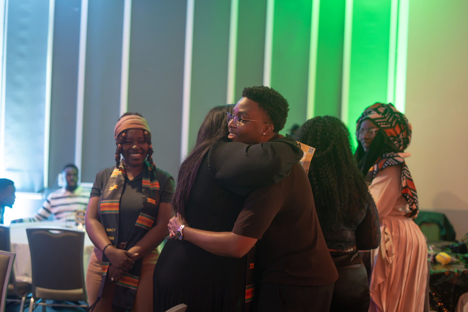 Two friends hug at the Legacy in the Making Black grad event.