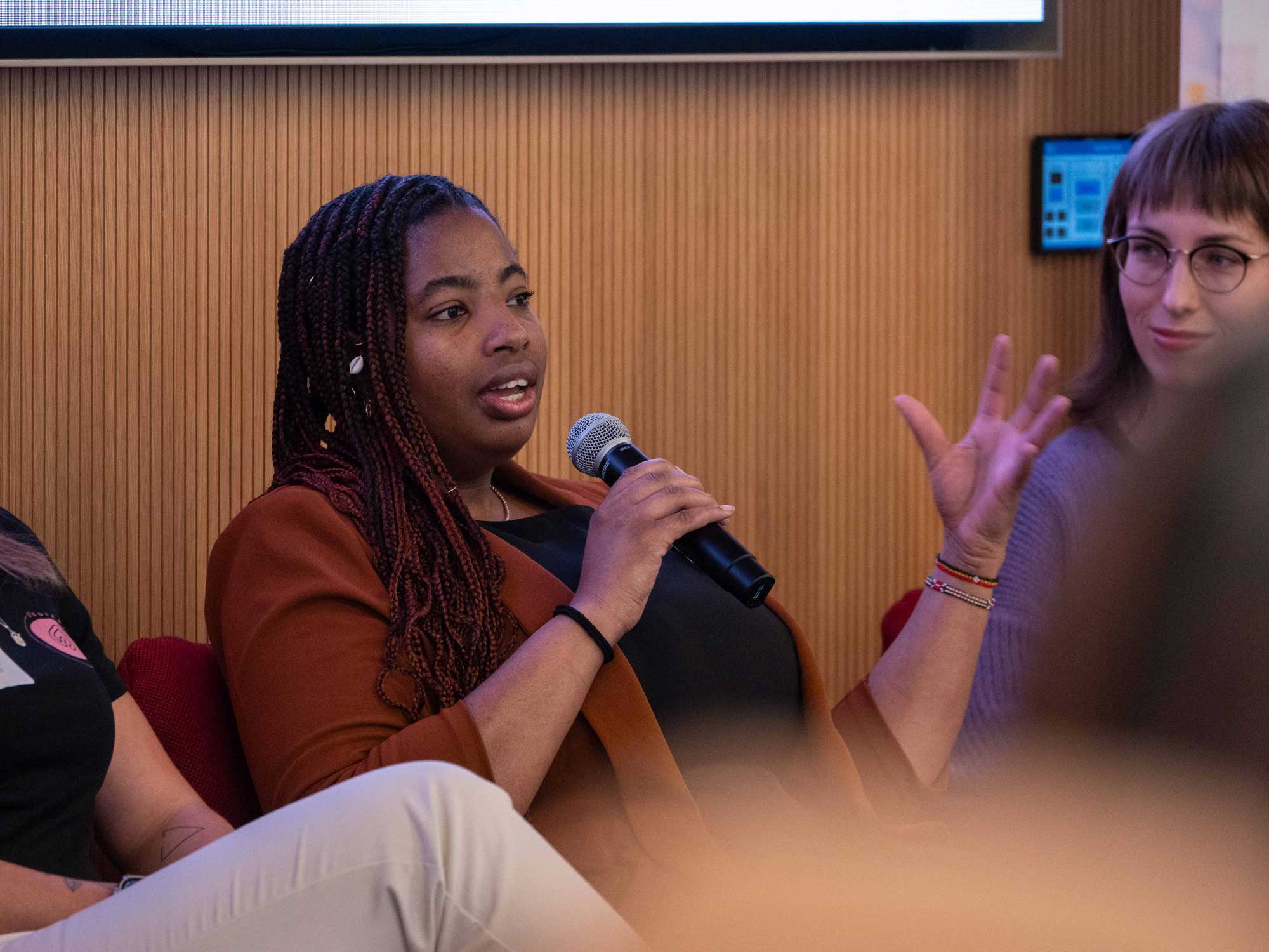 A woman is speaking to an unseen audience