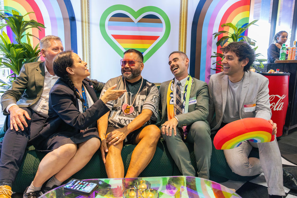 Employees gather for the opening of Pride House