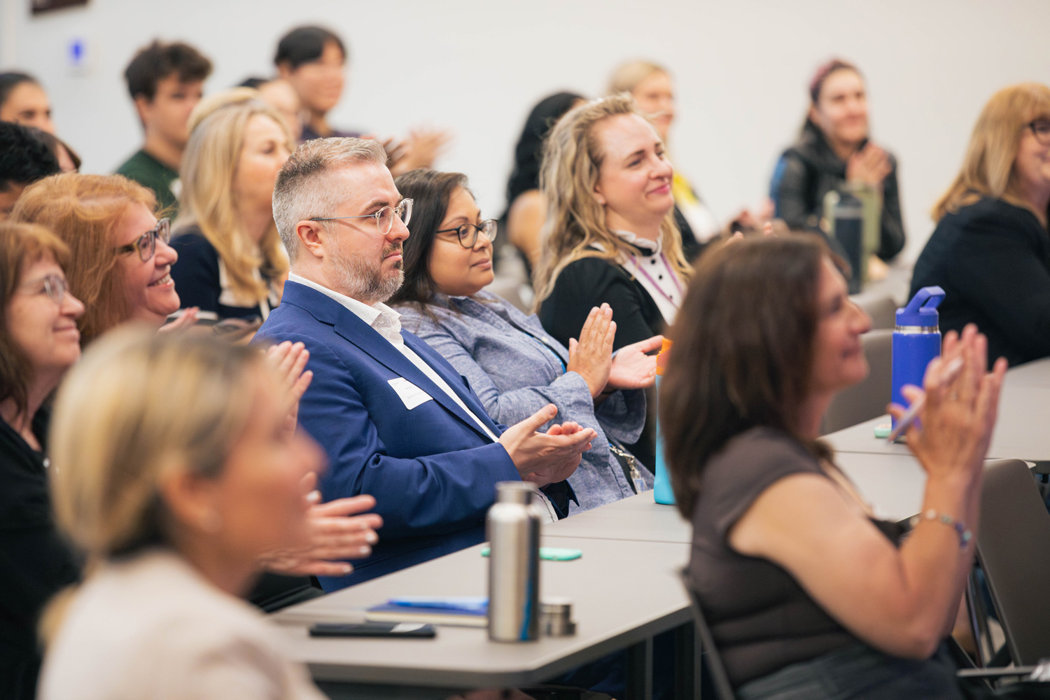 Guests clap for the panelists at the RISE showcase.