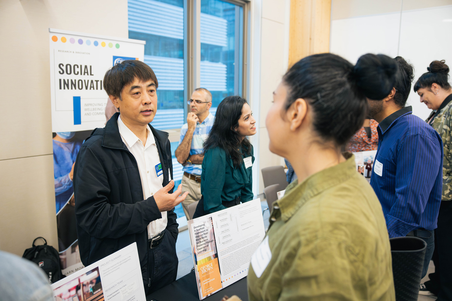 Guests engage with George Brown's research teams at the RISE showcase fair.