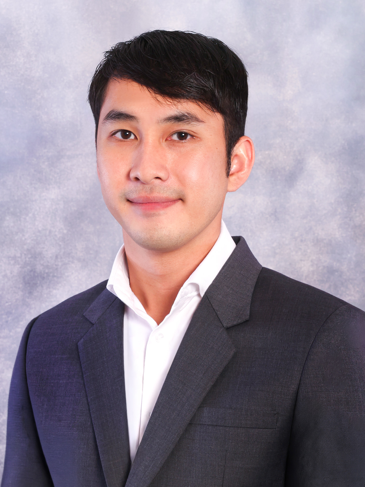 Headshot of Pachanon Scott Sanchon in a white shirt and blazer.