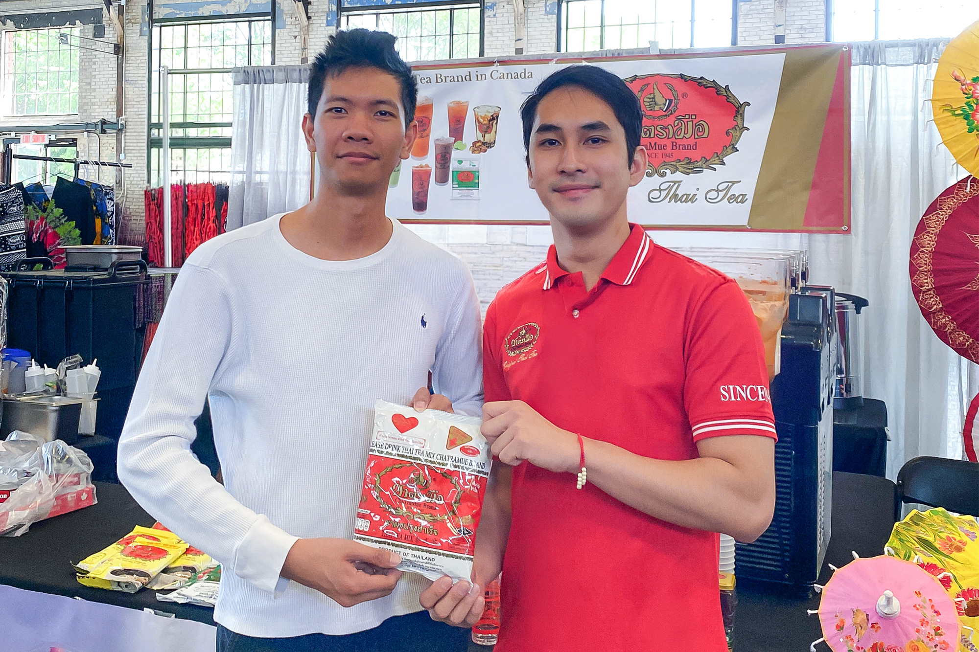 Pachanon Scott Sanchon shows off the ChaTraMue brand with his business partner.