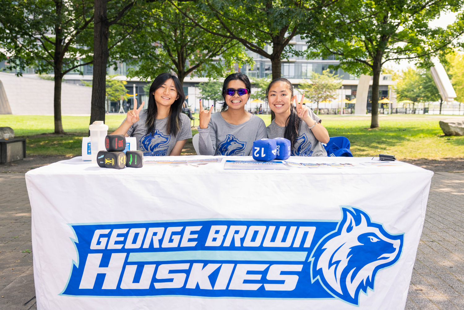 Athletics staff smile for the camera outside of Waterfront at the Summer Sounds event.