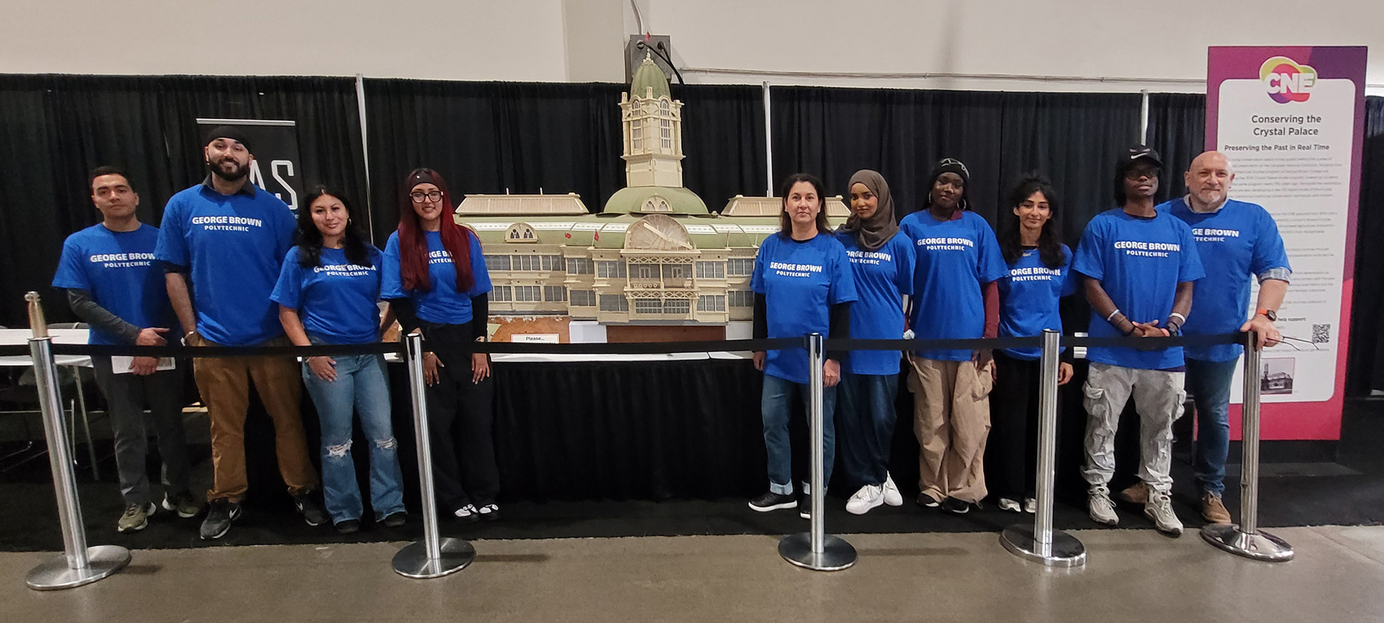 Group photo of Architecture students at the CNE standing in front of a scale model of the Crystal Palace.