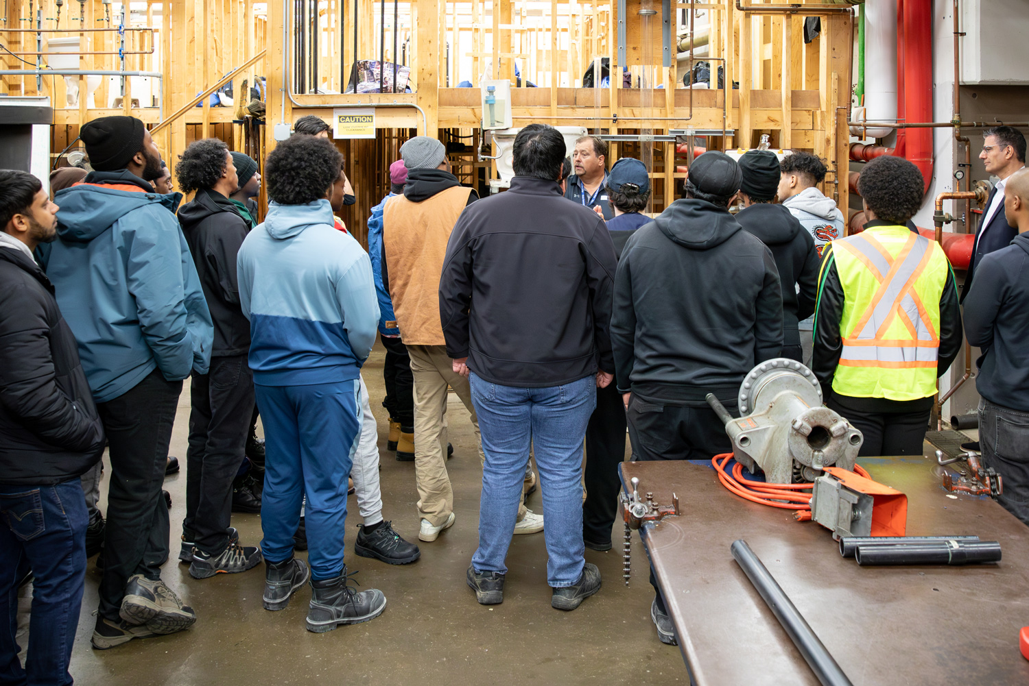 Students tour a plumbing lab as part of the BOLT Day of Discovery.