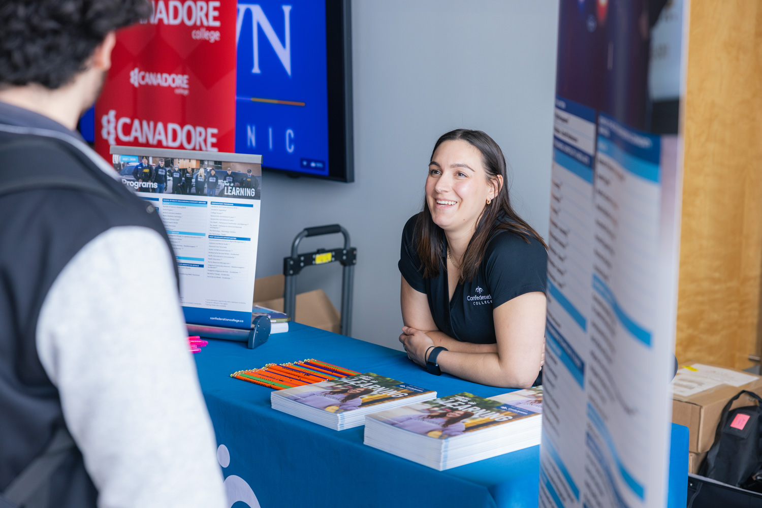 Visiting students talk to guest colleges at the Waterfront campus.