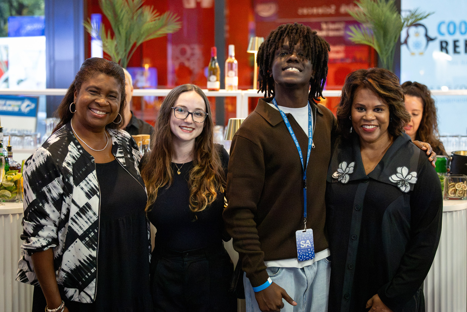 Four guests at the 2026 Food Court Social smile for the camera.