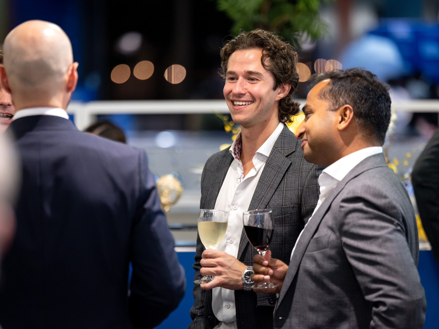 Guests hold drinks and chat at the 2026 Food Court Social.