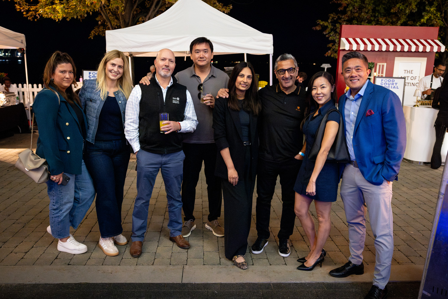 Guests on the Waterfront patio pose for a group photo at the Food Court Social.