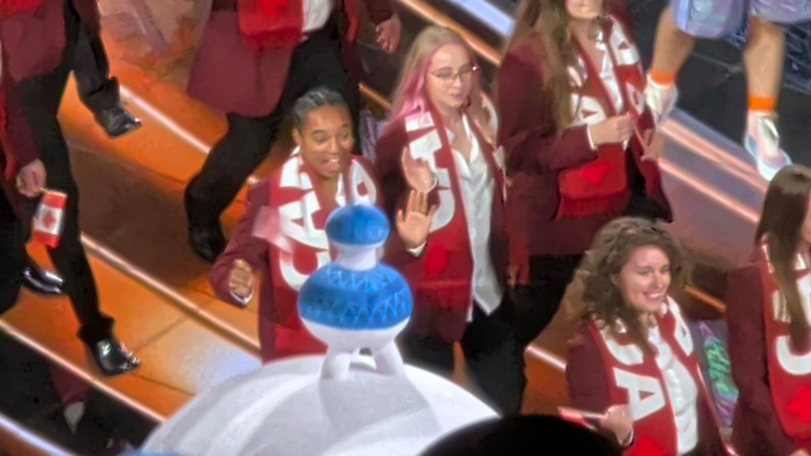 Luca Assad and team Canada enter the WorldSkills Competition wearing matching burgundy blazers and Canada scarves.
