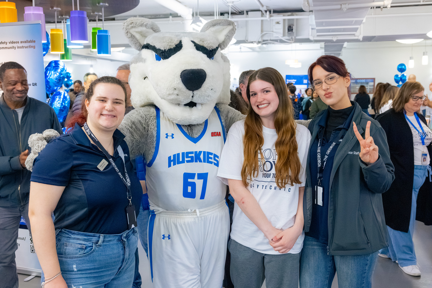 Guests and staff pose with Helder the Husky at the fall open house.