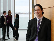 man in suit leaning against wall