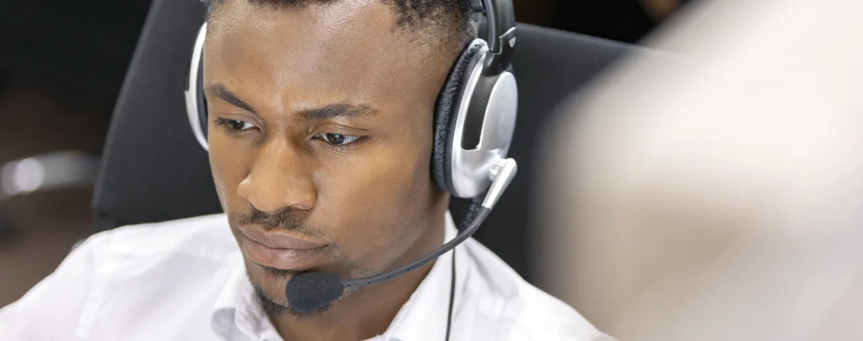 A participant using computer-delivered IELTS in a lab using headphones for listening