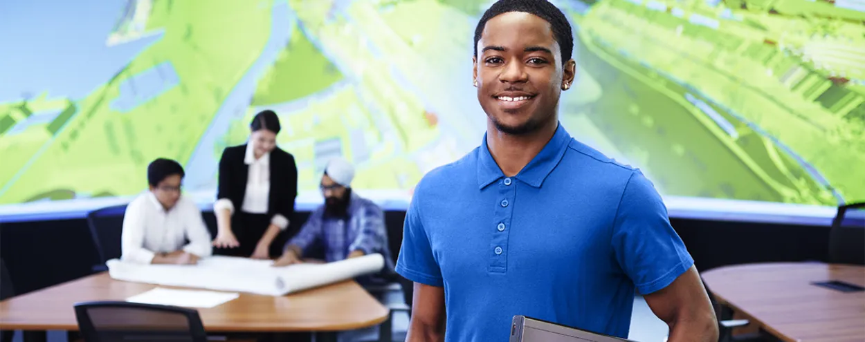 Building Information Modelling student holding a laptop