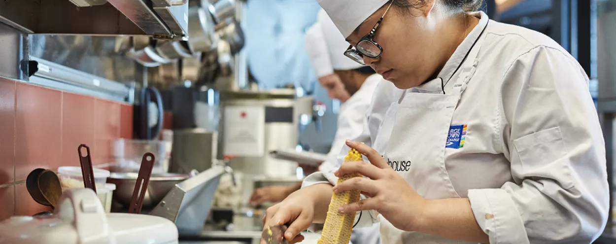 Student preparing food at The Chefs House