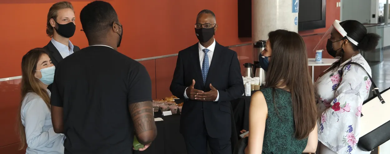 A photo of Dr. Gervan Fearon meeting students