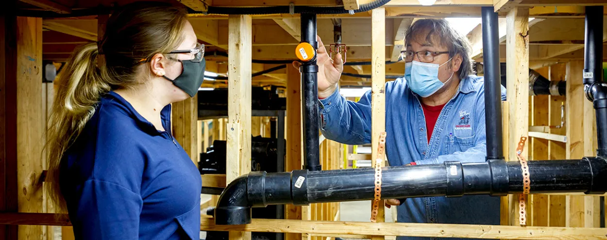 student and instructor at plumbing lab