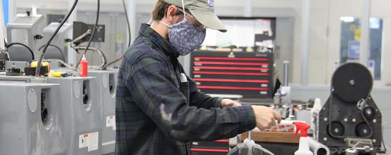Student working at a machine