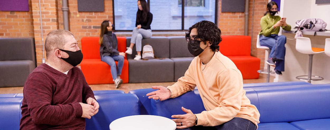 Masked students in lounge area