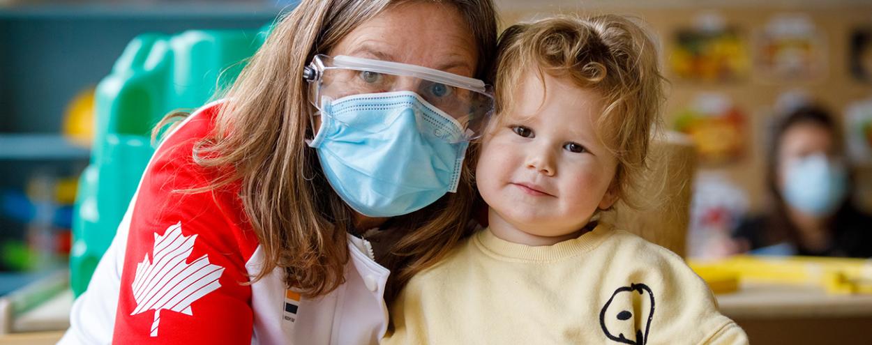 ECE wearing PPE with child