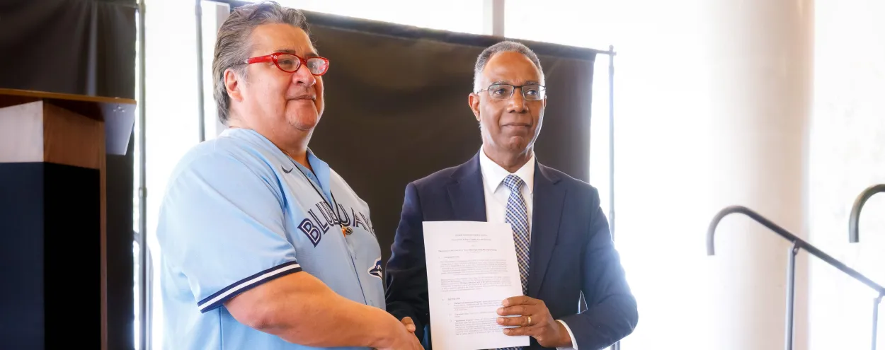 MCFN Chief Stacey Laforme and GBC Pres Gervan Fearon signing MOU