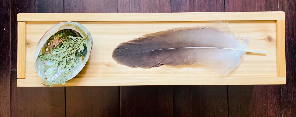The ceremonial Eagle Feather rests on a wooden case.
