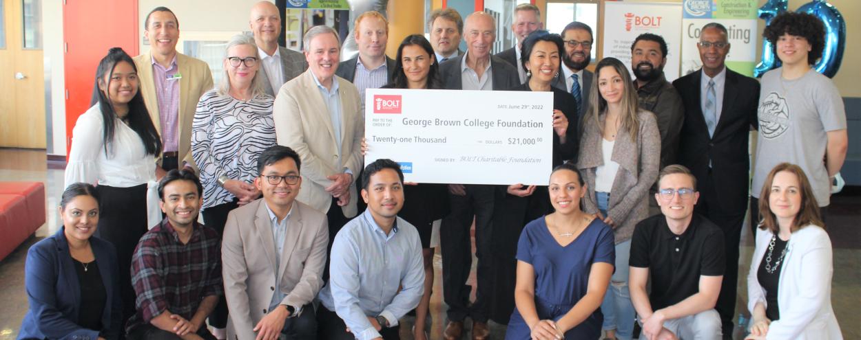 BOLT and GBC members gather around a large cheque