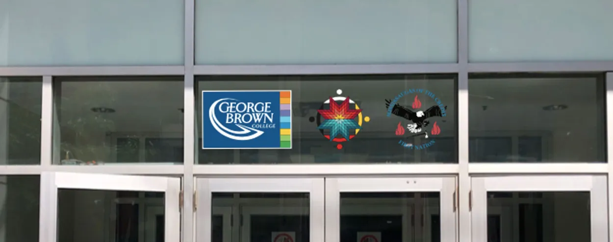 The crest of the Mississaugas of the Credit First Nation, along with the medallion of our Indigenous Initiatives team, proudly displayed next to the George Brown College logo above a campus doorway.