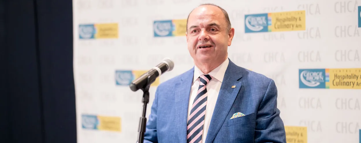 Chef John Higgins speaking at lecturn