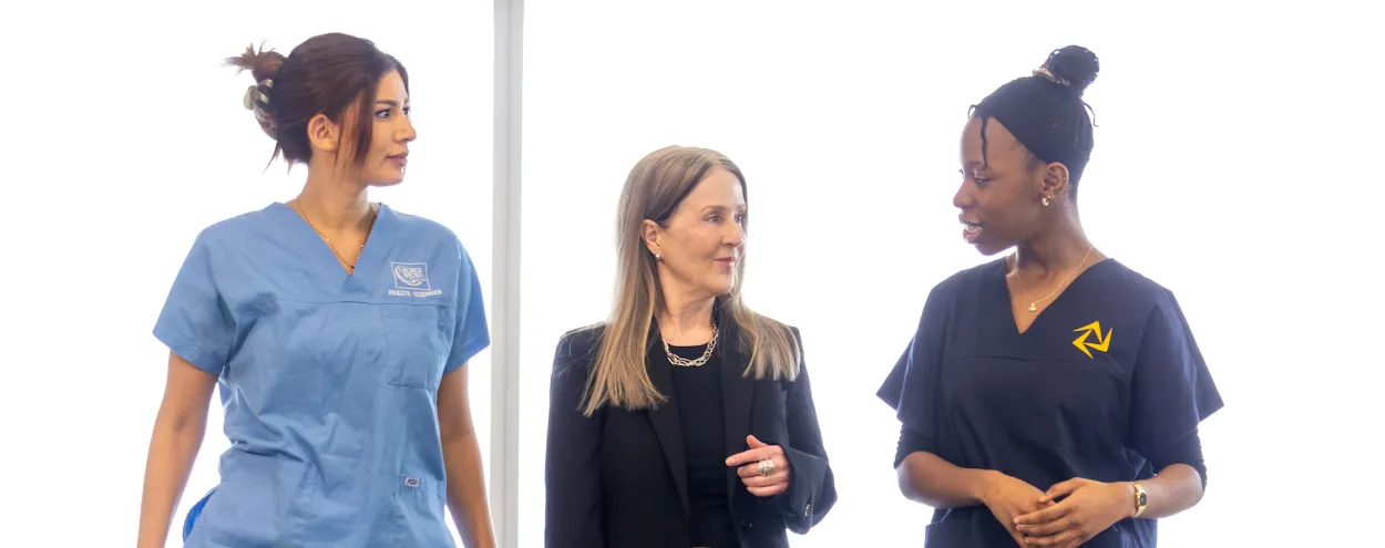 Nursing students walk with incoming Dean of Health Sciences, Dr. Wendy Ellis.