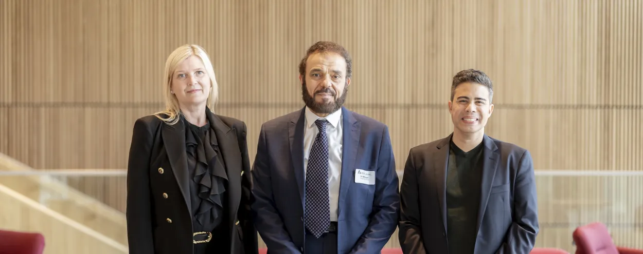 VP Michelle McCollum, Dean Adel Esayad and Professor Jon Callegher stand in Limberlost Place
