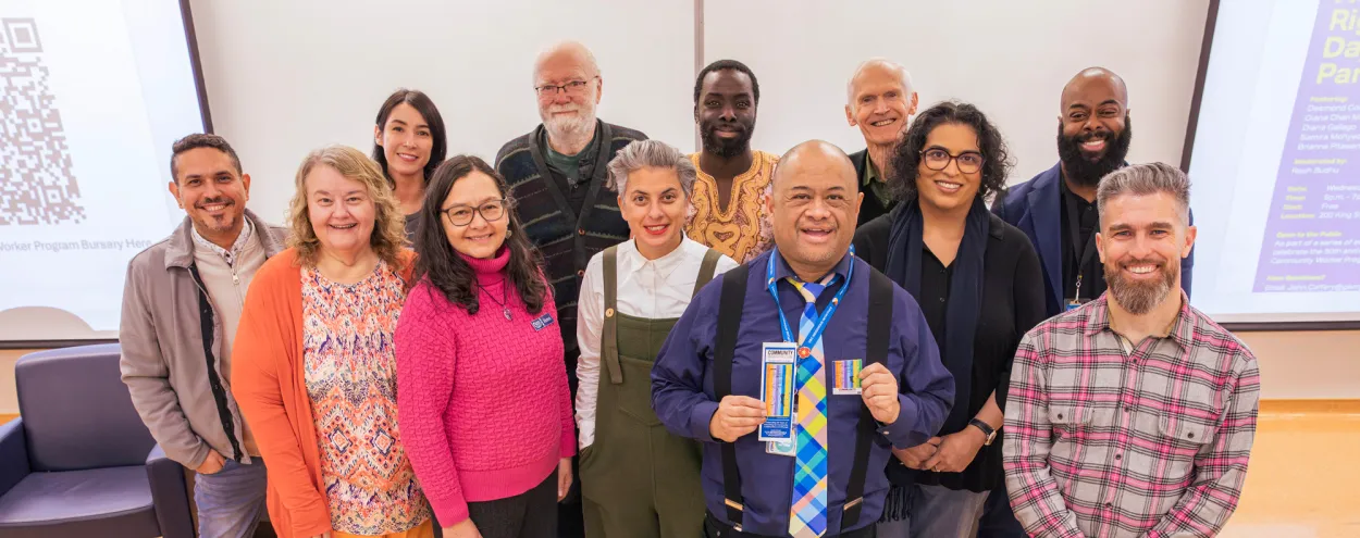 Panelists and staff pose as a group at the Human Rights Day event kicking off the 50th anniversary events for the Community Worker program