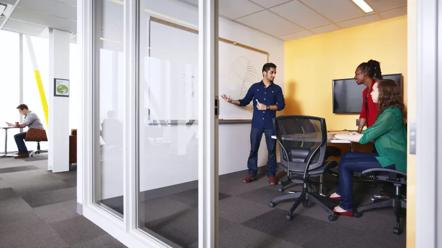 Three students study together in a study room at Waterfront campus.