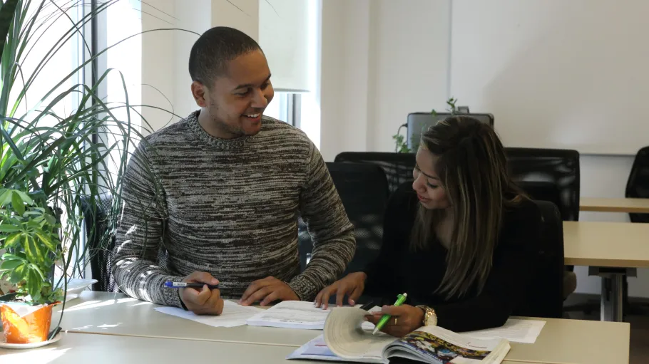 Two students working together to complete their homework.