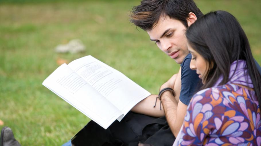 Man and woman looking at a textbook