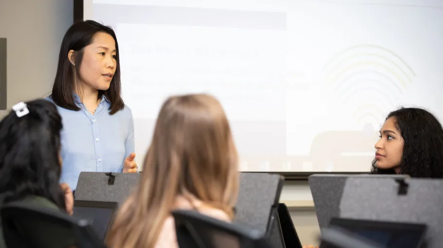 A librarian lecturing students in the computer lab at the Waterfront Library.