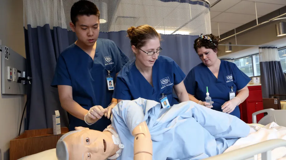 Personal Support Worker students practice on low fidelity mannequin in the Simulation Centre on Waterfront Campus.