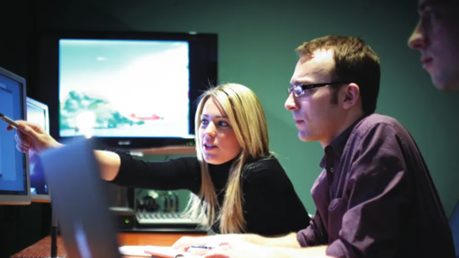 Students collaborating around a computer