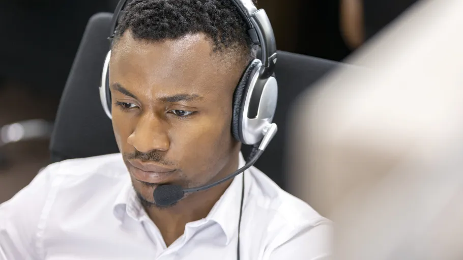 A participant using computer-delivered IELTS in a lab using headphones for listening