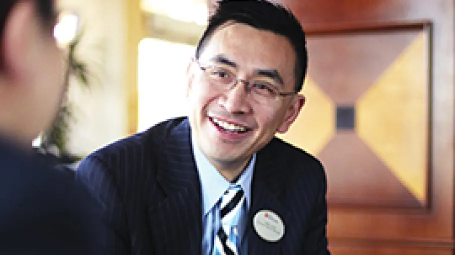 Hospitality grad at a front desk