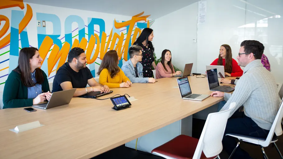 Students sitting at boardroom table