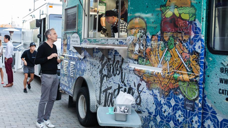 A man standing at a food truck